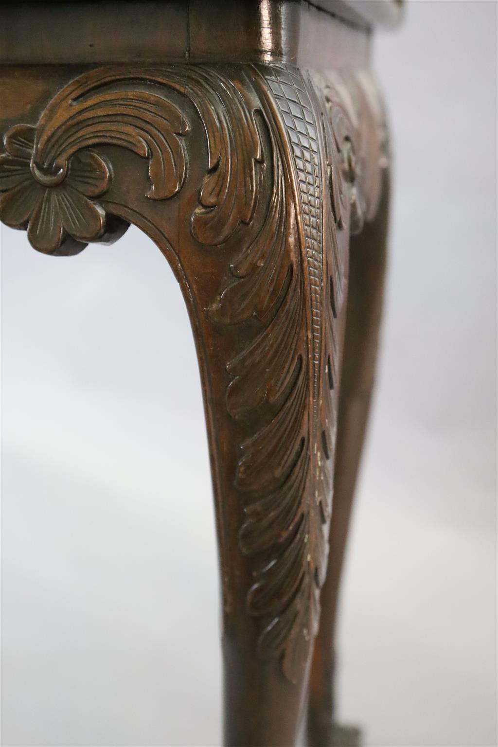 A mid-18th century Irish carved walnut folding top card table, W.2ft 9in. D.1ft 4in. H.2ft 5in.